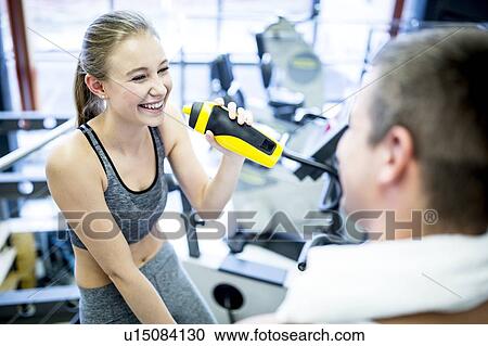 Woman drinking water in gym View Large Photo Image Stock Image - Woman drinking water in gym. Fotosearch