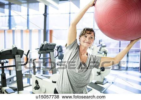 Woman exercising with fitness ball View Large Photo Image Stock Photo - Woman exercising with fitness ball. Fotosearch