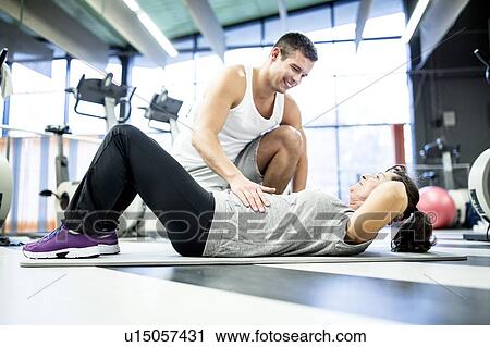 Woman exercising with trainer View Large Photo Image Stock Image - Woman exercising with trainer. Fotosearch