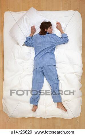 Woman lying in bed, asleep View Large Photo Image Stock Photo - Woman lying in bed, asleep. Fotosearch