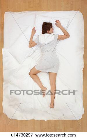 Woman lying in bed, asleep View Large Photo Image Stock Photo - Woman lying in bed, asleep. Fotosearch