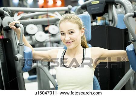 Stock Image - Woman using butterfly machine. Fotosearch
