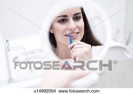Woman using interdental brush View Large Photo Image Picture - Woman using interdental brush. Fotosearch