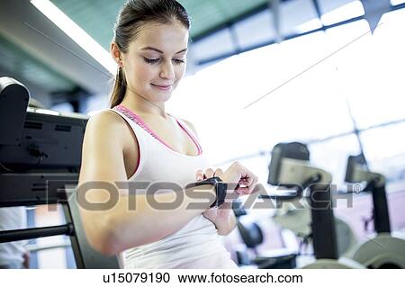 Stock Image - Woman using smart watch. Fotosearch