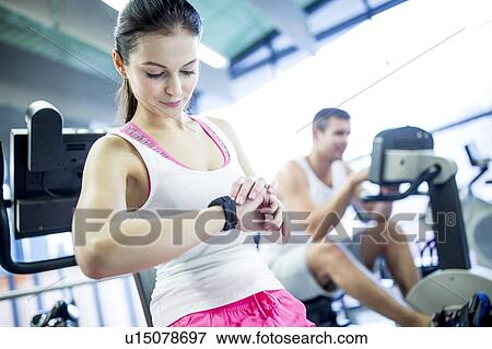 Stock Photo - Woman using smart watch. Fotosearch