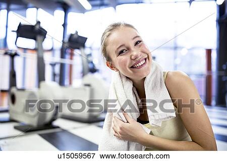 Woman wiping her sweat after exercising View Large Photo Image Stock Photo - Woman wiping her sweat after exercising. Fotosearch