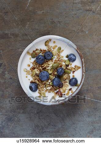Picture - Yogurt with granola and blueberries. Fotosearch