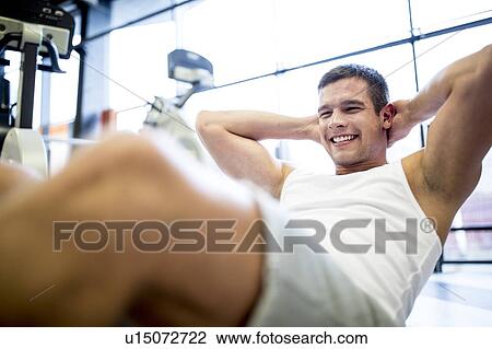 Stock Image - Young man exercising. Fotosearch