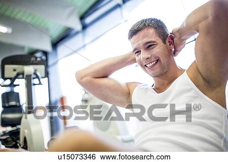 Stock Photograph - Young man exercising. Fotosearch