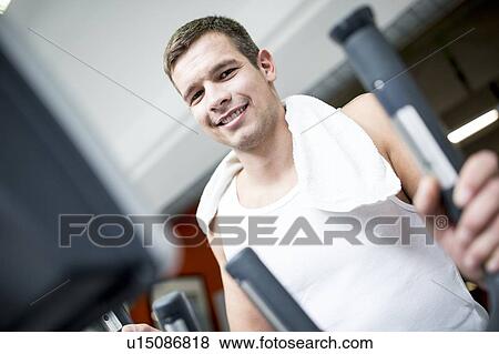 Stock Photo - Young man in gym, close-up, portrait. Fotosearch