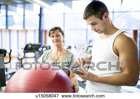 Young man using tablet View Large Photo Image Stock Photo - Young man using tablet. Fotosearch