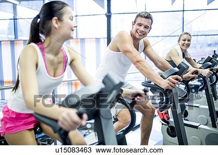 Young men and women working out in gym View Large Photo Image Stock Image - Young men and women working out in gym. Fotosearch