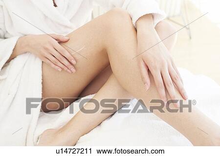Young woman applying cream to leg View Large Photo Image Stock Image - Young woman applying cream to leg. Fotosearch