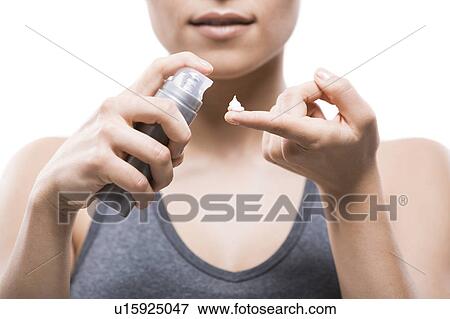 Young woman applying moisturizer View Large Photo Image Stock Photo - Young woman applying moisturizer. Fotosearch