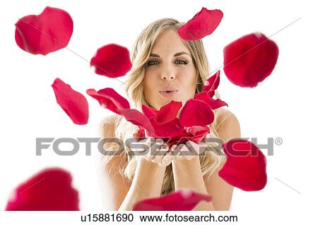 Young woman blowing rose petals off from hands View Large Photo Image Stock Image - Young woman blowing rose petals off from hands. Fotosearch