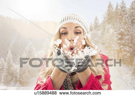 Young woman blowing snow off from hands View Large Photo Image Stock Photo - Young woman blowing snow off from hands. Fotosearch