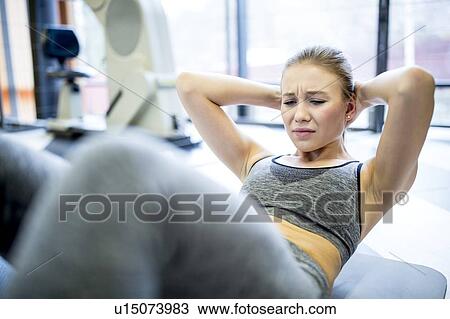 Young woman exercising View Large Photo Image Stock Image - Young woman exercising. Fotosearch