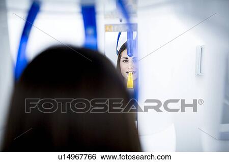 Stock Photograph - Young woman having dental x-ray. Fotosearch