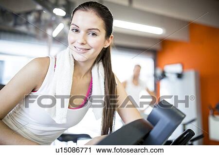 Young woman in gym View Large Photo Image Stock Image - Young woman in gym. Fotosearch