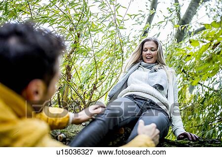 Young woman jumping from tree View Large Photo Image Stock Photo - Young woman jumping from tree. Fotosearch
