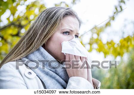 Young woman sneezing View Large Photo Image Stock Photo - Young woman sneezing. Fotosearch
