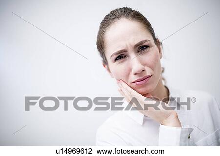 Stock Image - Young woman suffering toothache. Fotosearch