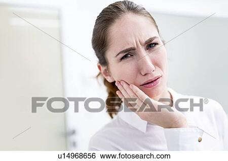 Stock Photograph - Young woman suffering toothache. Fotosearch