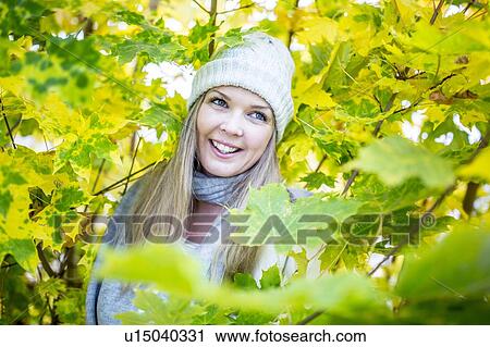Young woman surrounded by autumn leaves View Large Photo Image Stock Image - Young woman surrounded by autumn leaves. Fotosearch