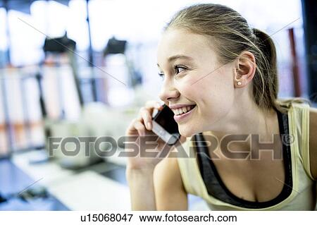 Young woman talking on mobile phone View Large Photo Image Stock Photo - Young woman talking on mobile phone. Fotosearch