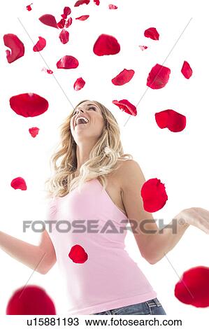 Young woman throwing up rose petals above head View Large Photo Image Stock Image - Young woman throwing up rose petals above head. Fotosearch