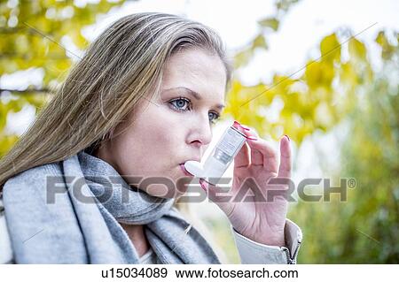 Young woman using inhaler View Large Photo Image Stock Photo - Young woman using inhaler. Fotosearch