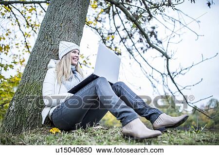 Young woman using laptop View Large Photo Image Stock Image - Young woman using laptop. Fotosearch