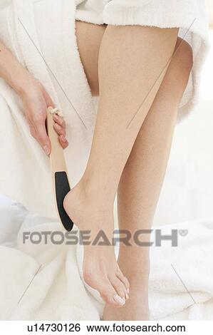 Young woman using pedicure equipment View Large Photo Image Stock Photograph - Young woman using pedicure equipment. Fotosearch