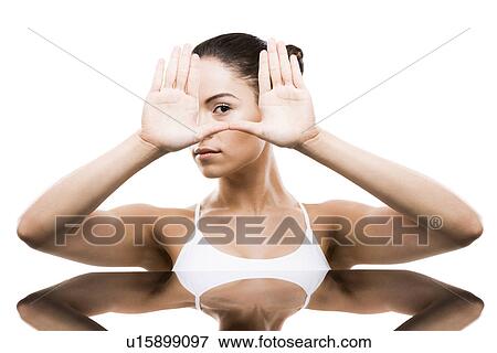 Young woman with hands in front of face View Large Photo Image Stock Photo - Young woman with hands in front of face. Fotosearch
