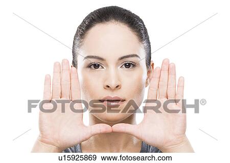 Stock Photo - Young woman with hands in front of face. Fotosearch