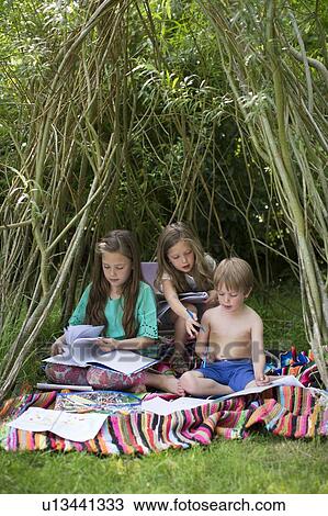 Children playing in a den outside View Large Photo Image Stock Image - Children playing in a den outside. Fotosearch