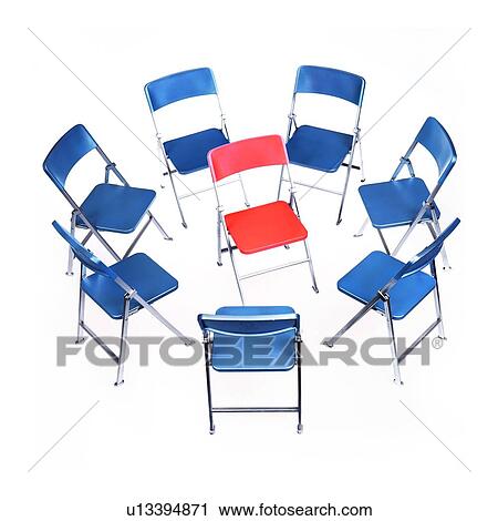 Stock Image - Circle of chairs with one in the middle. Fotosearch