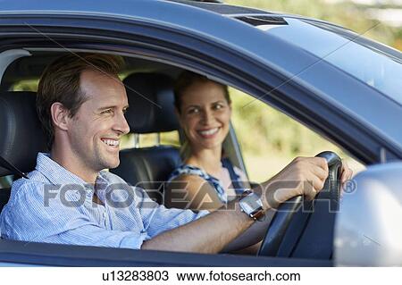 Stock Image - Couple driving in car. Fotosearch