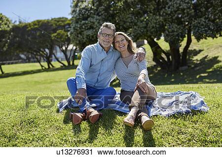 Couple on picnic blanket View Large Photo Image Stock Image - Couple on picnic blanket. Fotosearch