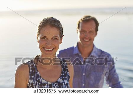 Couple smiling towards camera View Large Photo Image Stock Photography - Couple smiling towards camera. Fotosearch