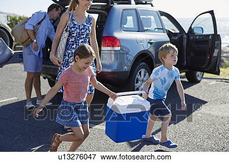 Family carrying picnic cold box View Large Photo Image Stock Photo - Family carrying picnic cold box. Fotosearch