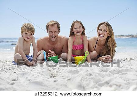 Stock Image - Family on the beach. Fotosearch