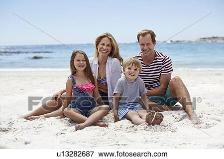 Family sitting on beach View Large Photo Image Stock Photo - Family sitting on beach. Fotosearch
