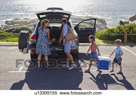 Family unpacking the car by the beach View Large Photo Image Stock Photography - Family unpacking the car by the beach. Fotosearch