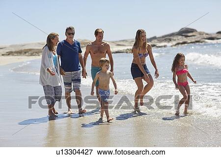 Family walking on beach View Large Photo Image Stock Photo - Family walking on beach. Fotosearch