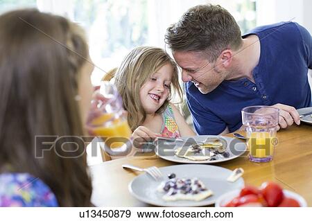 Father and daughter smiling at breakfast View Large Photo Image Stock Photo - Father and daughter smiling at breakfast. Fotosearch