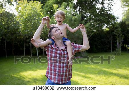 Father carrying son on his shoulders View Large Photo Image Stock Image - Father carrying son on his shoulders. Fotosearch