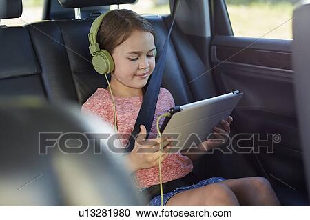 Stock Image - Girl wearing headphones. Fotosearch