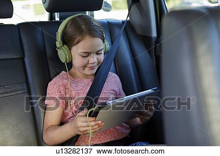 Stock Photo - Girl wearing headphones. Fotosearch