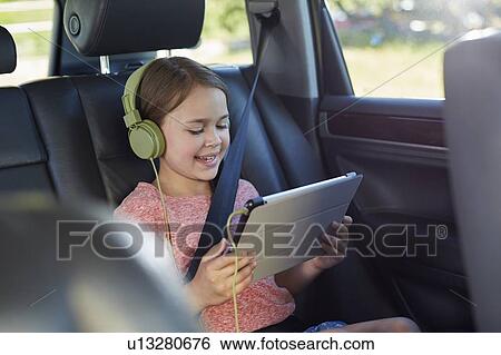 Girl wearing headphones View Large Photo Image Stock Photograph - Girl wearing headphones. Fotosearch